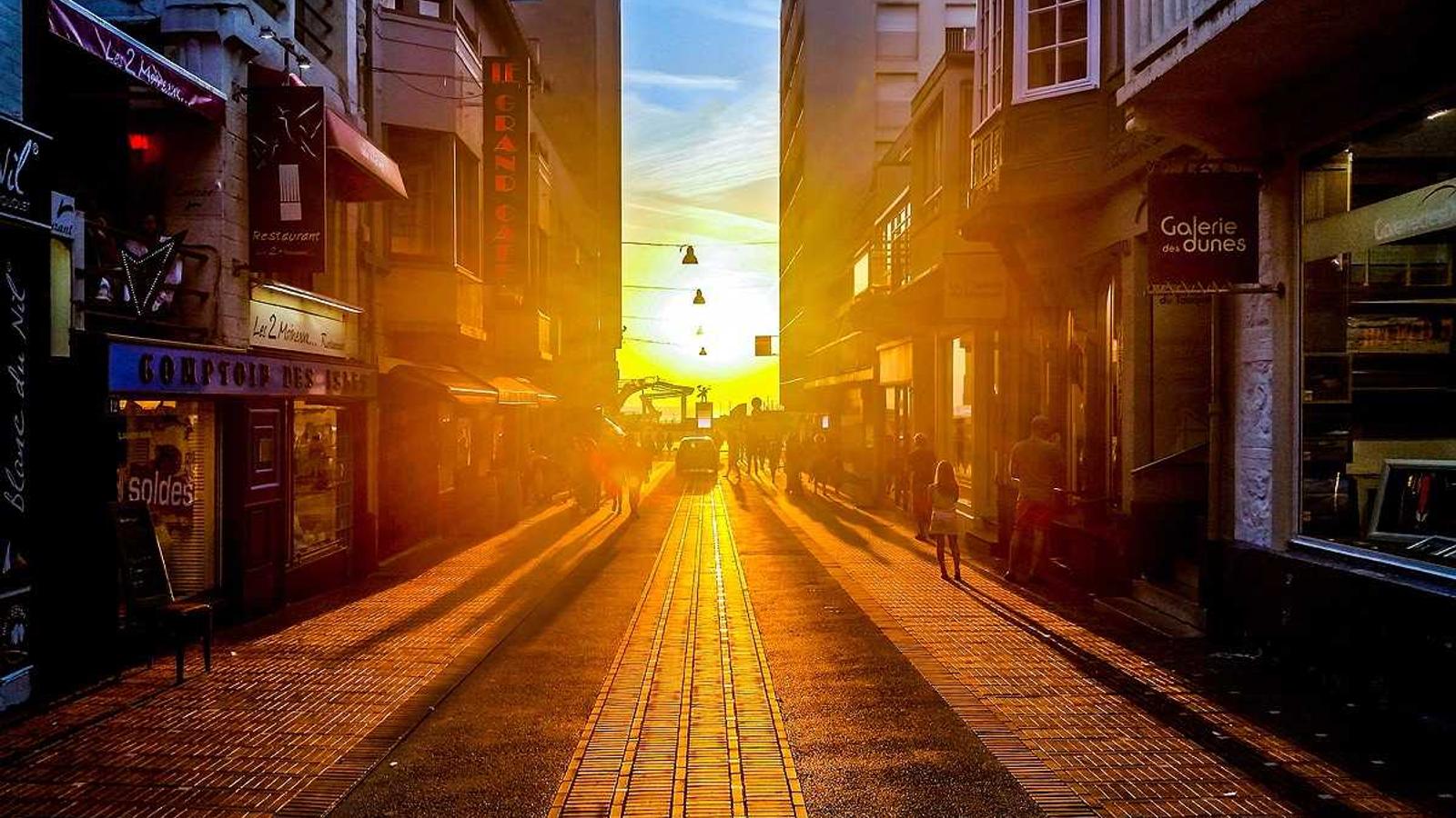 The input photo: sun setting at the end of a narrow street
